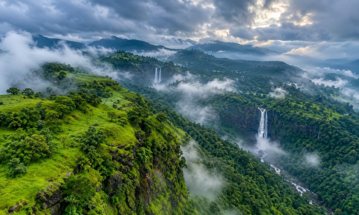 Green hills in mist representing monsoon captions for Instagram