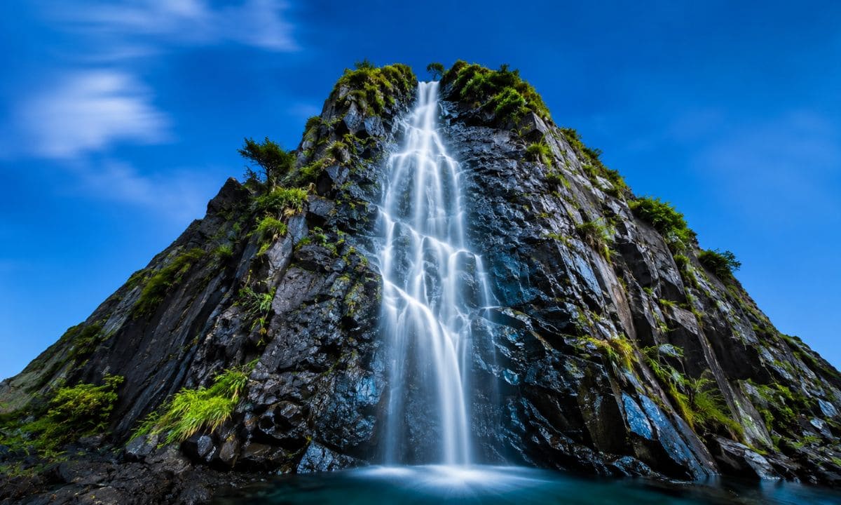Short and catchy waterfall captions for Instagram with minimalist rock waterfall
