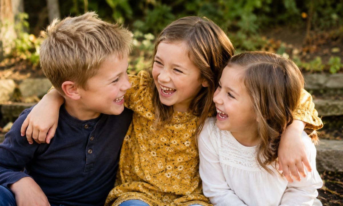Sibling quotes caption image showing three siblings laughing together outdoors Sibling quotes caption image showing three siblings laughing together outdoors